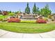 View of Oakhurst Glen entrance with colorful flowerbed and rock water feature at 7730 Demeter Dr, Fairburn, GA 30213