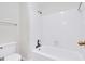 Bathroom featuring a standard bathtub, toilet, and tiled shower walls at 991 Lisa Kay Dr, Lawrenceville, GA 30046