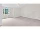 Bright, carpeted bedroom with a large window and ample natural light at 991 Lisa Kay Dr, Lawrenceville, GA 30046