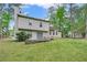 Home exterior showcasing backyard patio, lush greenery, mature trees, and ample natural light at 991 Lisa Kay Dr, Lawrenceville, GA 30046