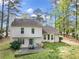 Home exterior showcasing backyard patio, lush greenery, mature trees, and ample natural light at 991 Lisa Kay Dr, Lawrenceville, GA 30046