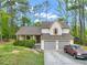 Charming home with a two-car garage, set back on a nicely wooded lot at 991 Lisa Kay Dr, Lawrenceville, GA 30046