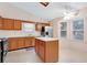 Functional kitchen with wood cabinets, stainless steel appliances, and an island at 991 Lisa Kay Dr, Lawrenceville, GA 30046