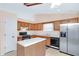 Functional kitchen with wood cabinets, stainless steel appliances, and an island at 991 Lisa Kay Dr, Lawrenceville, GA 30046