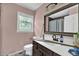 Bathroom featuring a single sink vanity, toilet, and tiled shower/tub area at 1315 Arden Sw Dr, Marietta, GA 30008