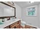 Modern bathroom features sink, wooden vanity, toilet, and window for natural light at 1315 Arden Sw Dr, Marietta, GA 30008