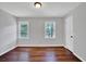 Bright bedroom with wood floors, neutral walls, and natural light from two windows at 1315 Arden Sw Dr, Marietta, GA 30008
