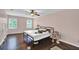 Bedroom with pink walls, wood floors, and two windows allowing ample natural light at 1315 Arden Sw Dr, Marietta, GA 30008