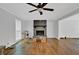 Spacious living room with hardwood floors, a brick fireplace, and a ceiling fan at 1315 Arden Sw Dr, Marietta, GA 30008