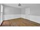 A well-lit room featuring wood floors and white wainscoting, creating a comfortable space at 1315 Arden Sw Dr, Marietta, GA 30008