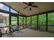 Inviting screened porch with wood flooring and ceiling fan offering serene views of the surrounding greenery at 1315 Arden Sw Dr, Marietta, GA 30008