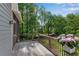 View of the backyard from the wood back deck with black metal railings and a gray pot of flowers at 2350 Shore View Nw Way, Suwanee, GA 30024