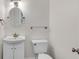 Well-lit half bathroom with white fixtures at 2350 Shore View Nw Way, Suwanee, GA 30024