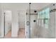 Bathroom showcasing glass shower with a mosaic accent stripe and view to the walk-in closet at 2350 Shore View Nw Way, Suwanee, GA 30024