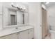 Well-lit bathroom with white vanity, large mirror, and shower featuring curtain at 2350 Shore View Nw Way, Suwanee, GA 30024