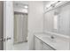 Clean, bright bathroom with a sink vanity, mirror, and shower with curtain at 2350 Shore View Nw Way, Suwanee, GA 30024