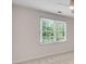Bright bedroom featuring a large window with natural light and neutral carpet at 2350 Shore View Nw Way, Suwanee, GA 30024
