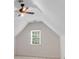 Attic bedroom with a pitched ceiling, ceiling fan and window at 2350 Shore View Nw Way, Suwanee, GA 30024