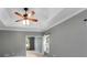 Bedroom with neutral walls, large window, ceiling fan and neutral carpet at 2350 Shore View Nw Way, Suwanee, GA 30024