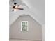 Attic bedroom featuring a window and neutral carpet flooring at 2350 Shore View Nw Way, Suwanee, GA 30024