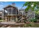 Rear exterior elevation of the two-story home with a screened porch and patio, perfect for outdoor living and entertaining at 2350 Shore View Nw Way, Suwanee, GA 30024
