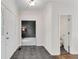 Inviting foyer with grey tile flooring and white trim throughout at 2350 Shore View Nw Way, Suwanee, GA 30024