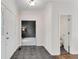 Bright hallway featuring tiled floors, white doors, and a view into adjacent rooms at 2350 Shore View Nw Way, Suwanee, GA 30024
