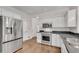 Updated kitchen with stainless steel appliances and white cabinets at 2350 Shore View Nw Way, Suwanee, GA 30024