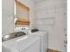 A well-equipped laundry room including shelving, window, and washer/dryer at 2350 Shore View Nw Way, Suwanee, GA 30024