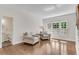 Cozy living room features hardwood floors, and bright windows with white shutters at 2350 Shore View Nw Way, Suwanee, GA 30024
