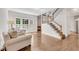 Bright living room with hardwood floors, a fireplace, and large windows at 2350 Shore View Nw Way, Suwanee, GA 30024
