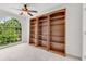 Office showcasing built-in bookcases and large window views of the backyard at 2350 Shore View Nw Way, Suwanee, GA 30024