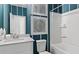 Stylish bathroom featuring striped walls, modern fixtures, and a bathtub with a shower, offering a serene retreat at 2447 Cadenza Cir, Dacula, GA 30019
