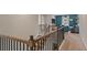 View of the upstairs hall railing looking into the second-story living room with lots of natural light at 2447 Cadenza Cir, Dacula, GA 30019