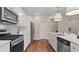 Modern kitchen with white countertops, stainless steel appliances, and wood-look flooring at 2447 Cadenza Cir, Dacula, GA 30019