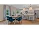Open-concept kitchen and dining area featuring white cabinets, stainless steel appliances, and a cozy breakfast nook at 2447 Cadenza Cir, Dacula, GA 30019