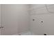 Empty laundry room area with white walls, washer and dryer hookups and wire shelf at 2447 Cadenza Cir, Dacula, GA 30019