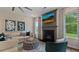 Beautiful living room with fireplace, modern decor, and great natural light creates a cozy and inviting atmosphere at 2447 Cadenza Cir, Dacula, GA 30019