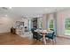 Open-concept living space with a fireplace, hardwood floors, and casual dining area at 2447 Cadenza Cir, Dacula, GA 30019