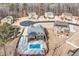 Aerial shot of a home with a pool and deck, surrounded by trees and other properties at 2994 Ash Grove Sw Dr, Conyers, GA 30094
