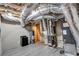 Unfinished basement with exposed ductwork, hot water tank and laminate flooring at 2994 Ash Grove Sw Dr, Conyers, GA 30094