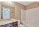 Bathroom featuring granite countertops, dark cabinets, and a shower-tub combo at 2994 Ash Grove Sw Dr, Conyers, GA 30094