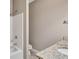 Bathroom with granite counters, shower, and neutral color palette at 2994 Ash Grove Sw Dr, Conyers, GA 30094
