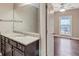 Bathroom featuring a vanity and hardwood flooring leading to the bedroom at 2994 Ash Grove Sw Dr, Conyers, GA 30094