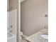 Bathroom featuring granite countertop vanity and shower with tile surround at 2994 Ash Grove Sw Dr, Conyers, GA 30094