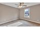 Neutral bedroom with a ceiling fan, carpet, and a window offering natural light at 2994 Ash Grove Sw Dr, Conyers, GA 30094