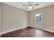 Neutral bedroom featuring hardwood floors, a ceiling fan, and a window for natural light at 2994 Ash Grove Sw Dr, Conyers, GA 30094