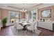 This formal dining room with natural light, hardwood floors, modern chandelier, and stylish furnishings at 2994 Ash Grove Sw Dr, Conyers, GA 30094