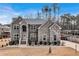Stunning two-story home with a stone and brick facade, lush landscaping, and a welcoming front porch at 2994 Ash Grove Sw Dr, Conyers, GA 30094