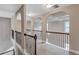 Hallway with arched openings, decorative railings, and elegant lighting at 2994 Ash Grove Sw Dr, Conyers, GA 30094